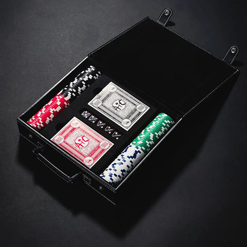 Black leather poker set case containing red, green, and white chips with a skull design on the playing cards.