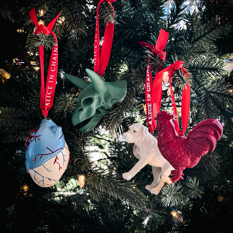 Alice in chains holiday ornament box set featuring a green triceratops skull heart dog and red rooster figurines