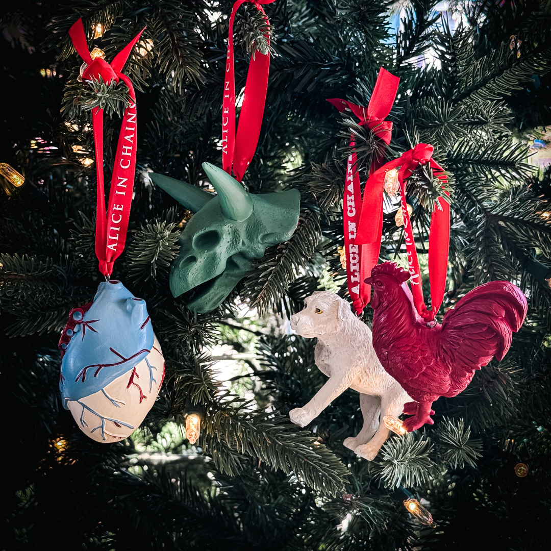 Alice in chains holiday ornament box set featuring a green triceratops skull heart dog and red rooster figurines