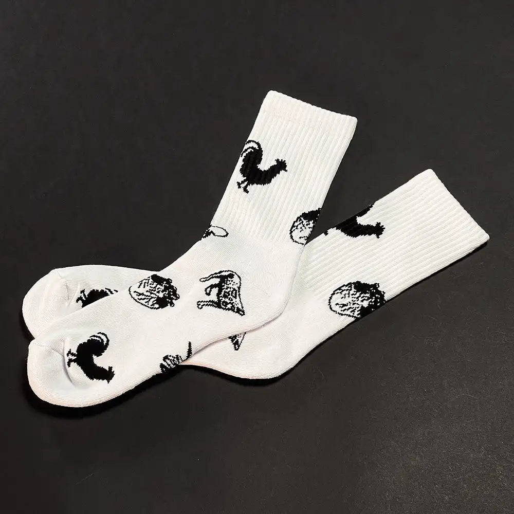 White crew socks featuring black embroidered animal silhouettes.